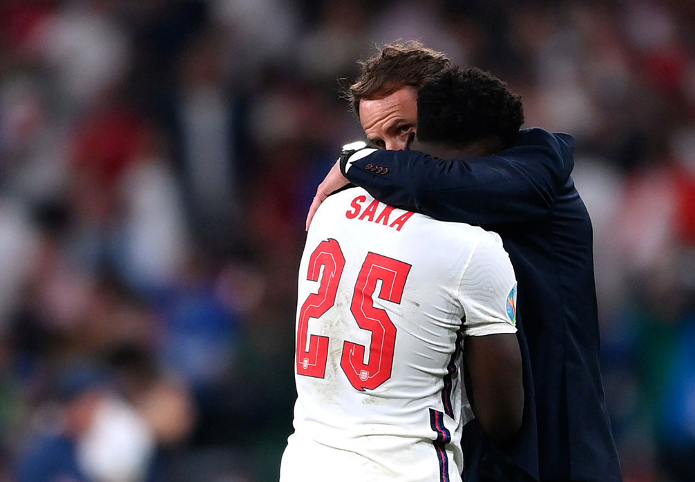 Gareth Southgate comforts Bukayo Saka following his missed penalty in Euro 2020 final.